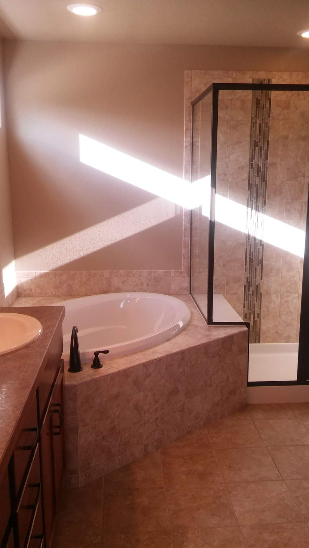 Bathroom detail — tub, tile and mirrors gleaming